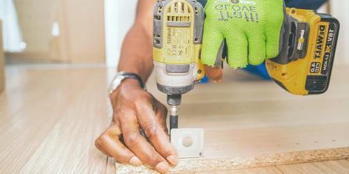 man drilling wood